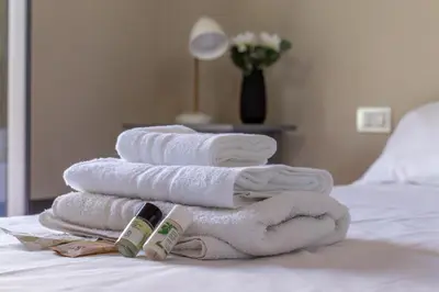 a pile of towels sitting on top of a bed at iFlat Magical flat by the Tiber in Rome