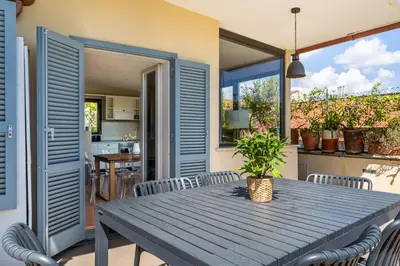 a wooden table and chairs on a patio at iFlat Magical flat by the Tiber in Rome
