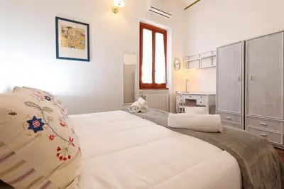a bedroom with two white beds and a window at Cornelia - Charme Apartment in Rome