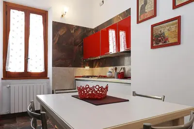 a kitchen with a table with a red basket on it at Cornelia - Charme Apartment in Rome
