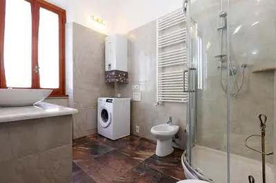 a bathroom with a shower and a toilet and a sink at Cornelia - Charme Apartment in Rome