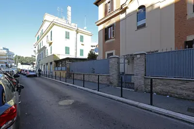 a street with buildings and a fence on the side at Cornelia - Charme Apartment in Rome