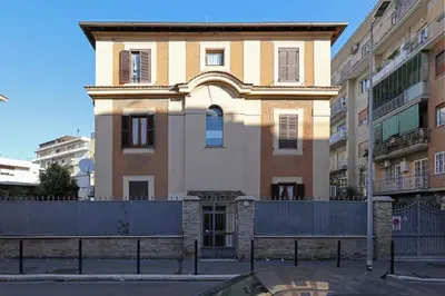 a building with a fence in front of it at Cornelia - Charme Apartment in Rome