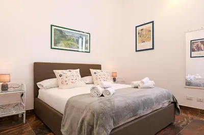 a bedroom with a bed with towels on it at Cornelia - Charme Apartment in Rome