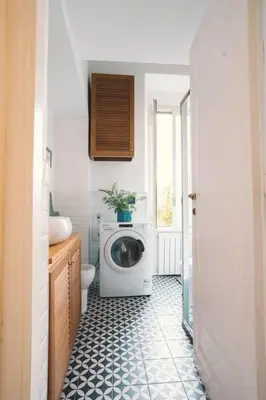 a bathroom with a washing machine and a toilet at Vaticano/Trastevere Floreal Suite in Rome