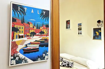 a room with a painting of a river with boats at MusicArt House in Rome