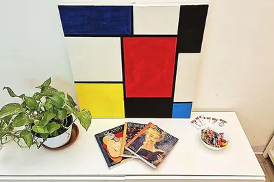 a table with a book and a plant and a painting at MusicArt House in Rome