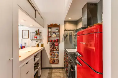 a red refrigerator in a kitchen with a counter at Cozy Flat in Vatican Area with private terrace in Rome
