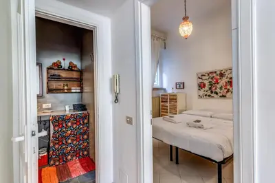 a bedroom with a bed and a table in a room at Cozy Flat in Vatican Area with private terrace in Rome