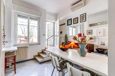 a living room with a table and chairs at Cozy Flat in Vatican Area with private terrace in Rome