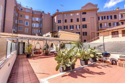 a courtyard with potted plants and buildings at Cozy Flat in Vatican Area with private terrace in Rome