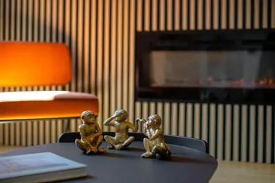 three small figurines sitting on a table in a room at Scipioni Luxury Suite (3 camere, 3 bagni) in Rome