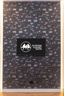 a sign on a wall with a patterned wallpaper at Scipioni Luxury Suite (3 camere, 3 bagni) in Rome