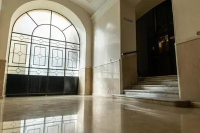 an empty lobby with a large window and stairs at Scipioni Luxury Suite (3 camere, 3 bagni) in Rome
