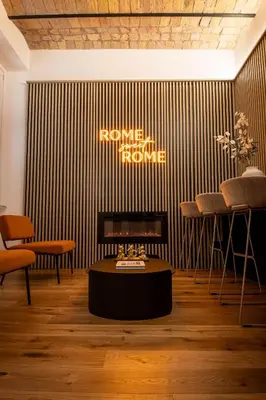 a room with a fireplace and a table and chairs at Scipioni Luxury Suite (3 camere, 3 bagni) in Rome