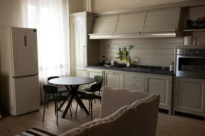 a kitchen with a table and chairs and a refrigerator at Merulana Penthouse: 5 minutes WALK from Colosseum in Rome