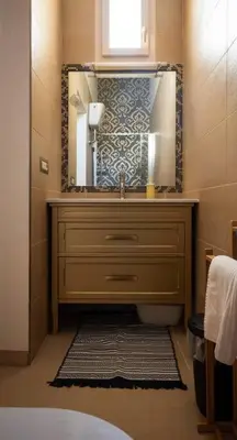 a bathroom with a sink and a mirror at Merulana Penthouse: 5 minutes WALK from Colosseum in Rome