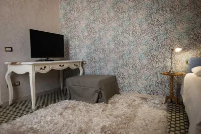 a bedroom with a desk with a television on it at Merulana Penthouse: 5 minutes WALK from Colosseum in Rome