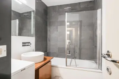 a bathroom with a shower and a tub and a sink at iFlat Pantheon 's Gem in Rome