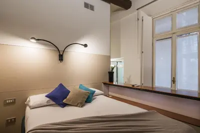 a bedroom with a bed with pillows and a window at iFlat Pantheon 's Gem in Rome