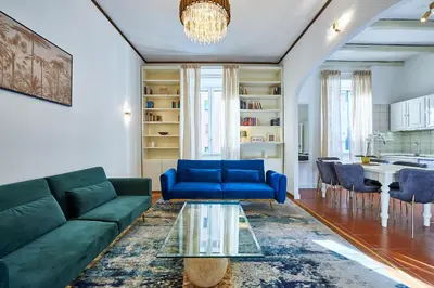 a living room with a blue couch and a table at Vatican 2BR Walk to St Peters IREX Apartment in Rome