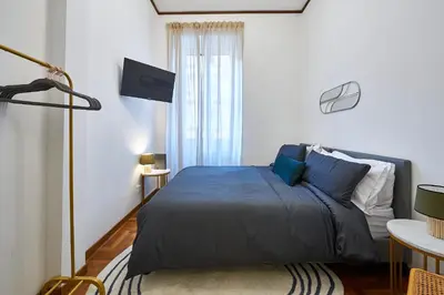 a living room with a blue couch and a table at Vatican 2BR Walk to St Peters IREX Apartment in Rome