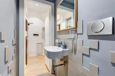 a bathroom with a sink and a mirror at TRASTEVERE SUITE EXPERIENCE in Rome