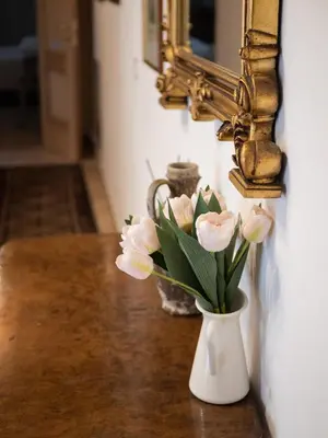 a vase filled with pink flowers sitting on a table at Minerva House Pantheon in Rome