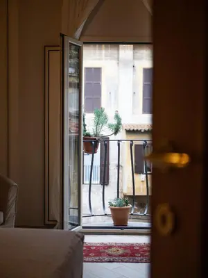 a room with a view of a balcony with potted plants at Minerva House Pantheon in Rome