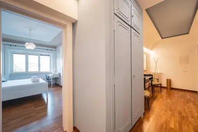 a bedroom with a door leading to a dining room at St. Peter Twilight BuddyRent in Rome