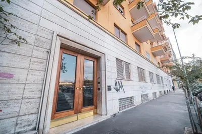 a building with glass doors on the side of a street at St. Peter Twilight BuddyRent in Rome