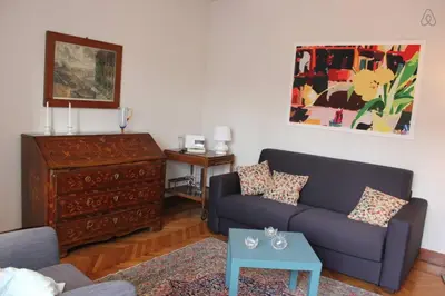 a living room with a couch and a table at Charming Apartment Piazza del Popolo in Rome