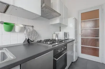 a kitchen with a stove top oven next to a sink at Charming Apartment Piazza del Popolo in Rome