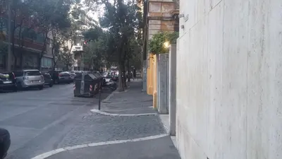 a city street with cars parked on the side of a building at Charming Apartment Piazza del Popolo in Rome