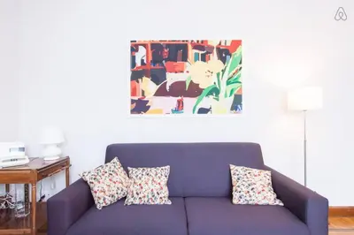 a purple couch with pillows in a living room at Charming Apartment Piazza del Popolo in Rome