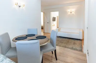 a dining room with a table and chairs and a couch at Giò House - Palazzo Storico in Rome