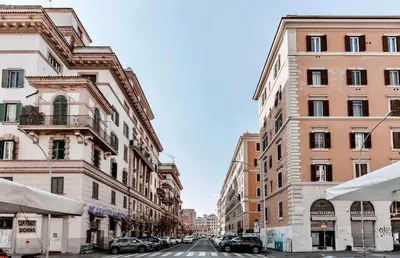 a city street with tall buildings and cars parked at Giò House - Palazzo Storico in Rome