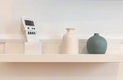 a shelf with vases and a clock on it at Giò House - Palazzo Storico in Rome