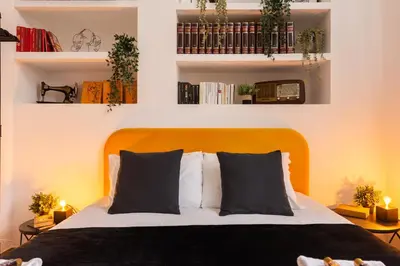 a bedroom with a bed with black and white pillows at Appartamento via di Porta Labicana in Rome