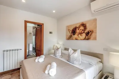a bedroom with two beds and a painting on the wall at Twilight Terrace - Piazza di Spagna in Rome