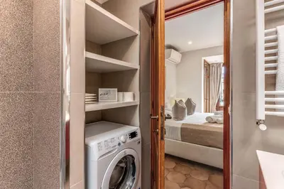 a laundry room with a washer and dryer at Twilight Terrace - Piazza di Spagna in Rome