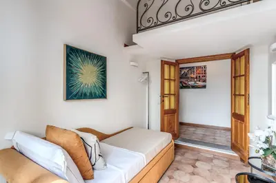 a living room with a couch and a window at Twilight Terrace - Piazza di Spagna in Rome