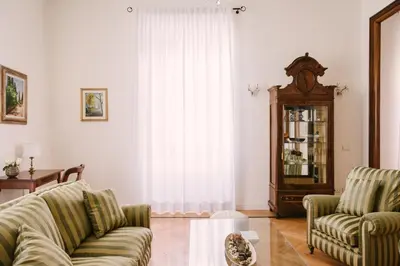 a living room with two couches and a clock at Appartamento Roma Vaticano 