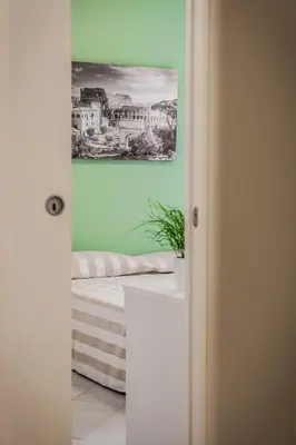 a room with a bed and a painting on the wall at Vatican Rooms Holiday in Rome in Rome