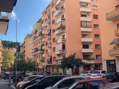 a parking lot in front of a tall building at Vatican Rooms Holiday in Rome in Rome