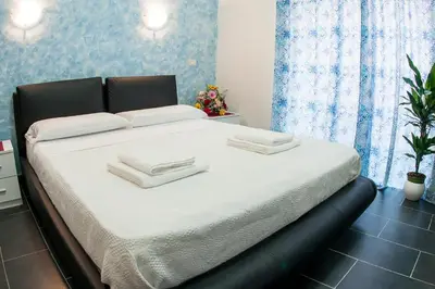 a bed with white sheets and towels on it at Gio' Suites in Rome