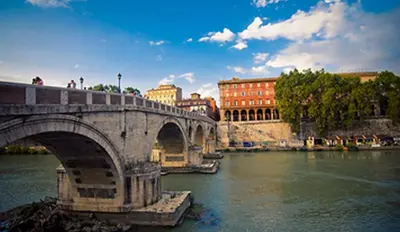 a bridge over a river in a city at Gio' Suites in Rome