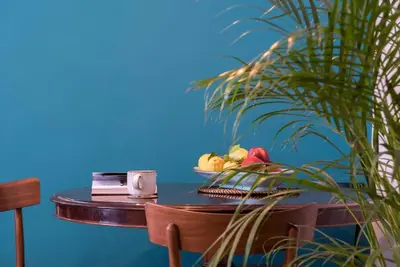 a table with a plate of fruit on a blue wall at Testaccio Boutique Apartment in Rome