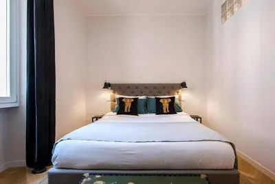 a bedroom with a large bed in a room at Testaccio Boutique Apartment in Rome