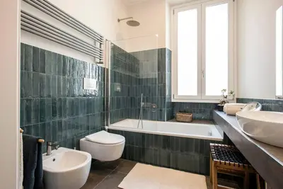 a bathroom with two sinks and a tub and a toilet at Testaccio Boutique Apartment in Rome